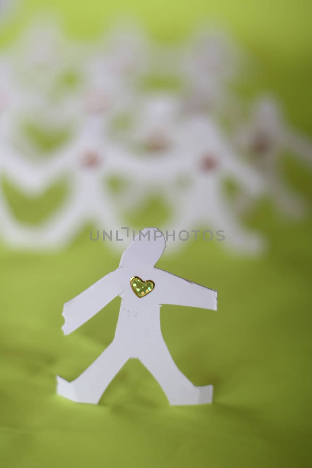 small rudimentary figures of man in paper
