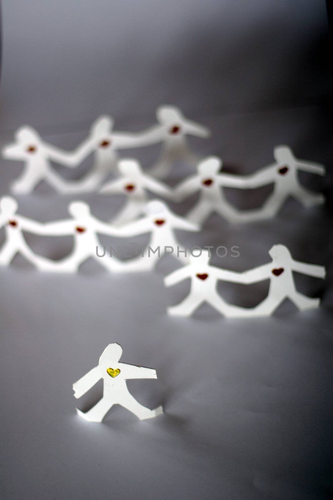 small rudimentary figures of man in paper