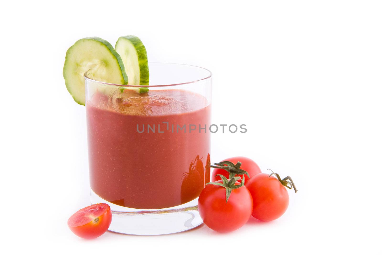 Fresh tomato juice with slices of cucumber isolated on white