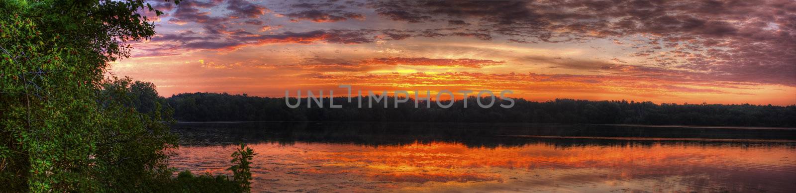 Panorama of a sunrise on a lake.