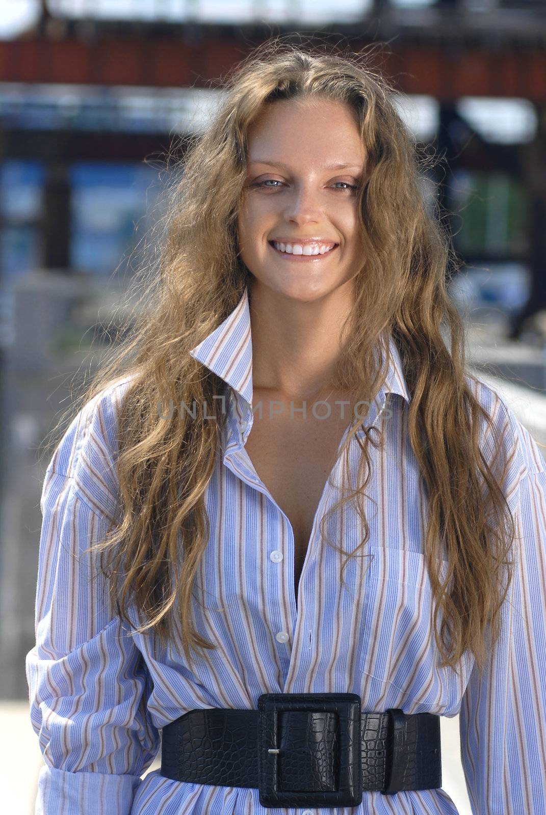 Portrait of a happy young collegian on color background