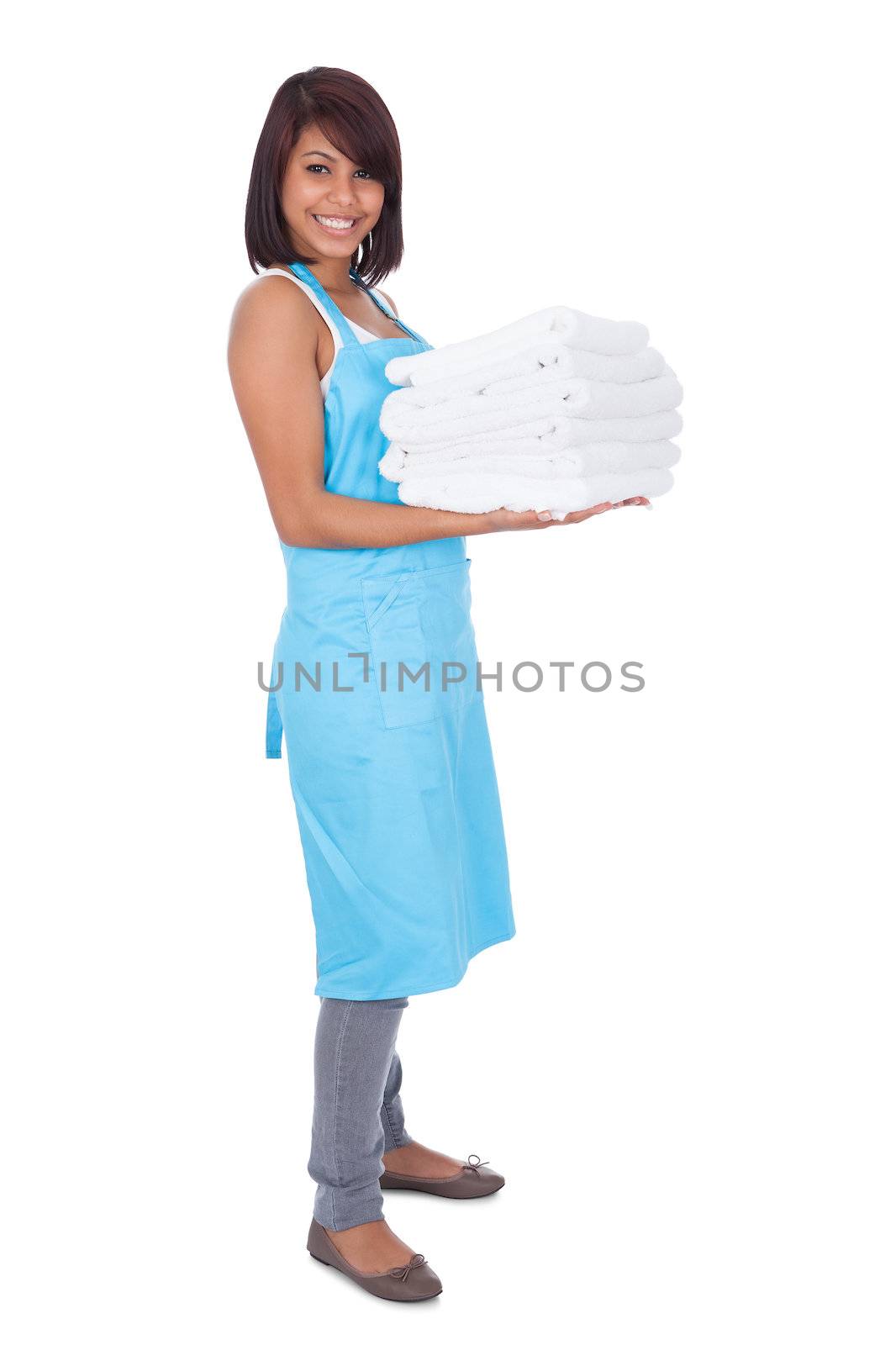 Smiling maid woman with towels by AndreyPopov