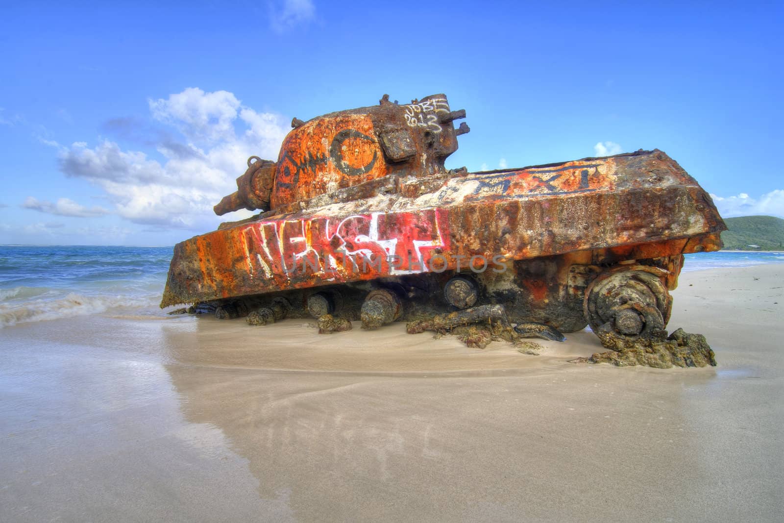 Old remnant tank partially sunk in sand at Flamenco Beach on the tropical island of Isla Culebra, Puerto Rico