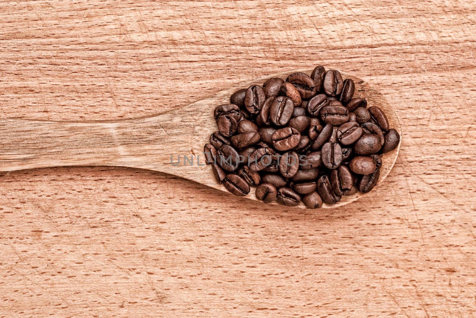 wooden spoon from coffee on a wooden table