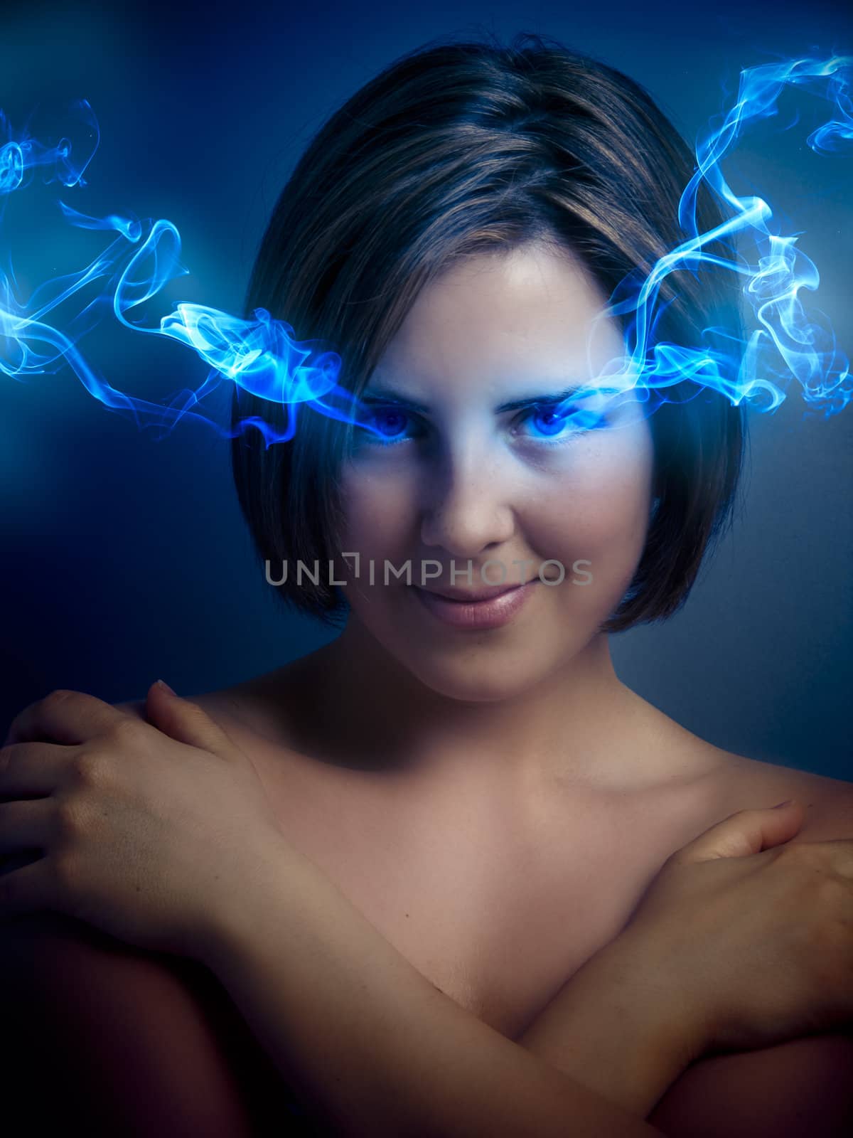 Beautiful young woman with blue eyes, blue smoke coming out of his eyes
