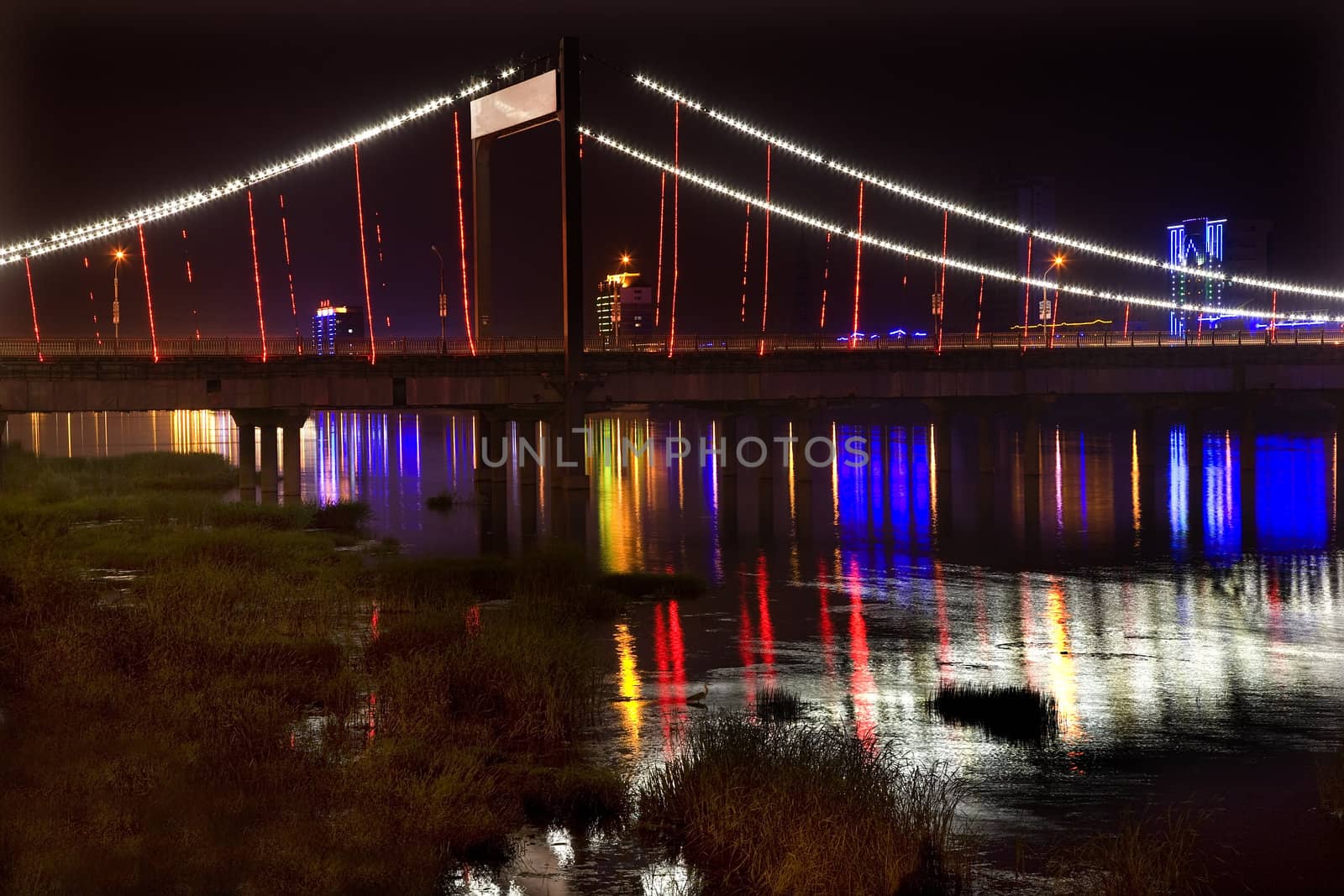 Jiangqun Qiao, General Bridge, Fushun City, Liaoning Province, China, Night Shot of Colored lights and reflections. Electricity in rural China.

Resubmit--In response to comments from reviewer have further processed image to reduce noise, sharpen focus and adjust lighting.