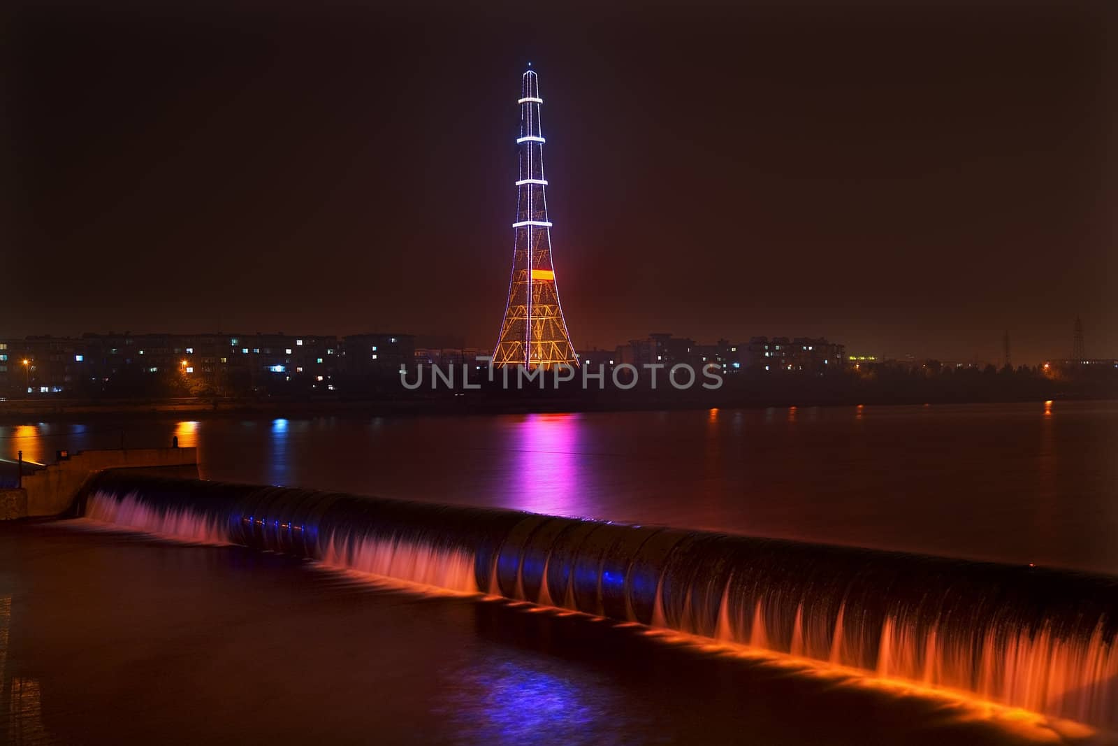 Electricity in Rural China, Radio Tower, waterfal at night with lightsl, Fushun City, Liaoning Province, China

Resubmit--In response to comments from reviewer have further processed image to reduce noise, sharpen focuse and adjust lighting.
