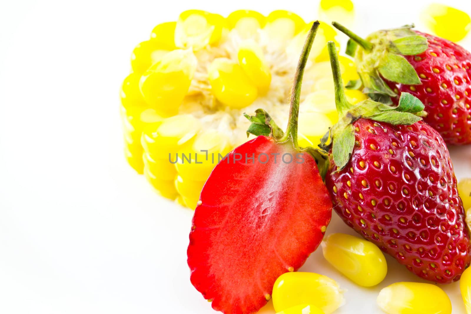 strawberries and corn placed on a white background