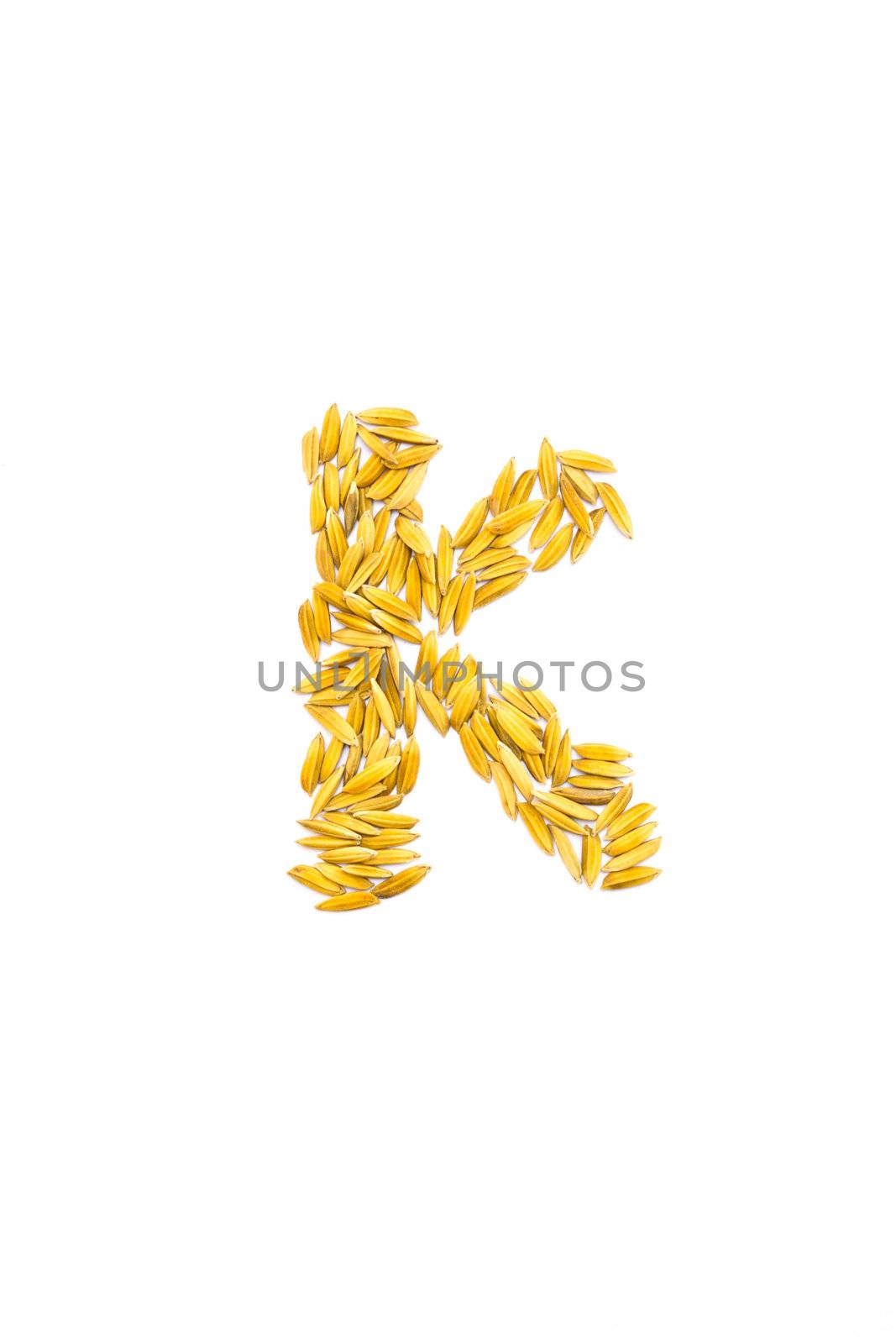 K letter of rice on a white background