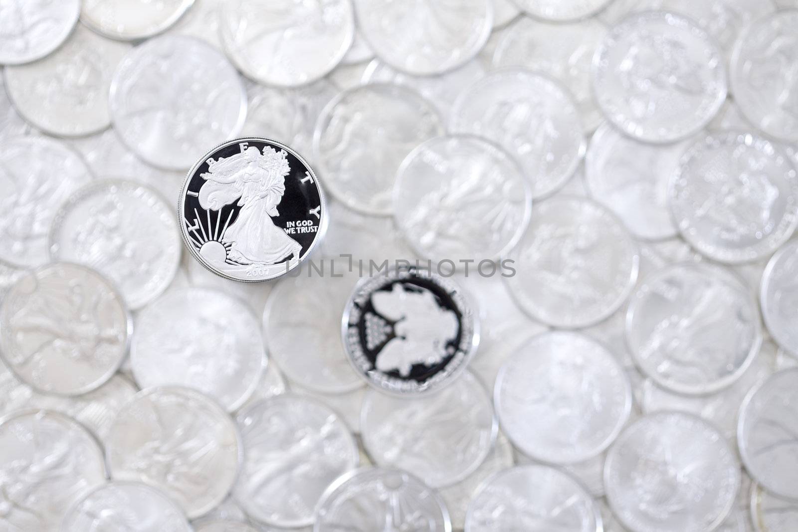 Silver shiny one dollar coins isolated on blurred money background
