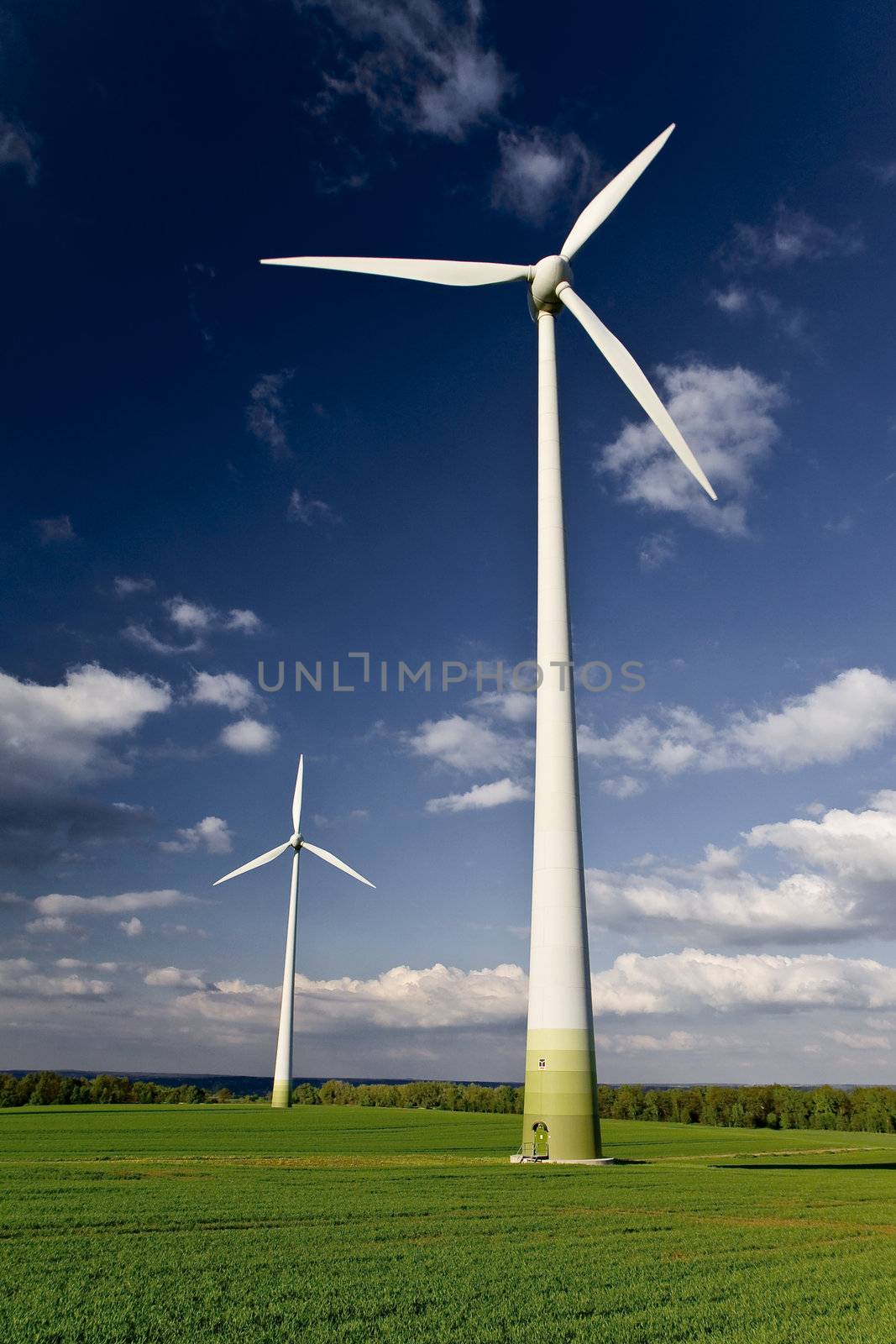Windmills against a blue sky and clouds, alternative energy source