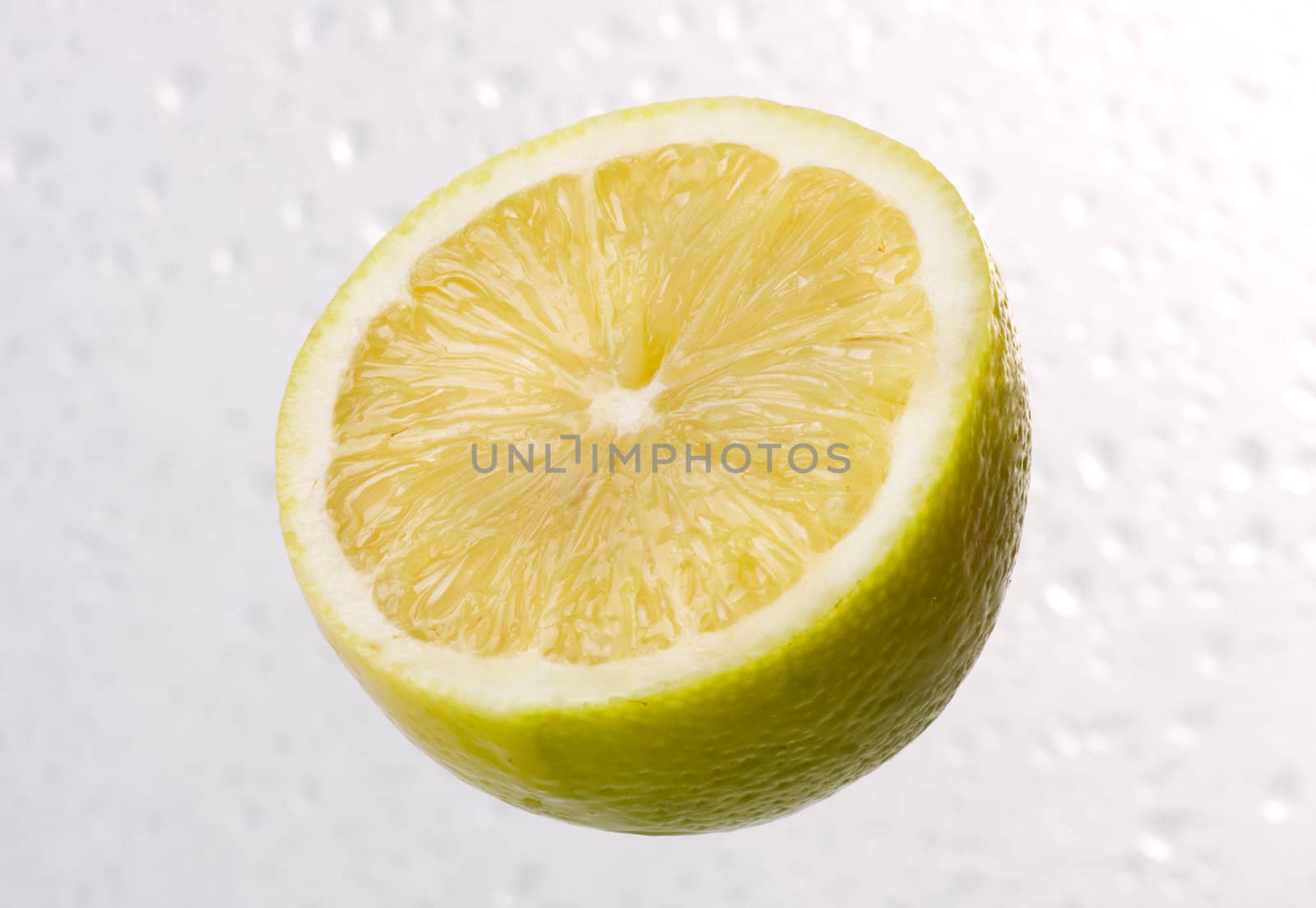 Yellow lemon on dewy background