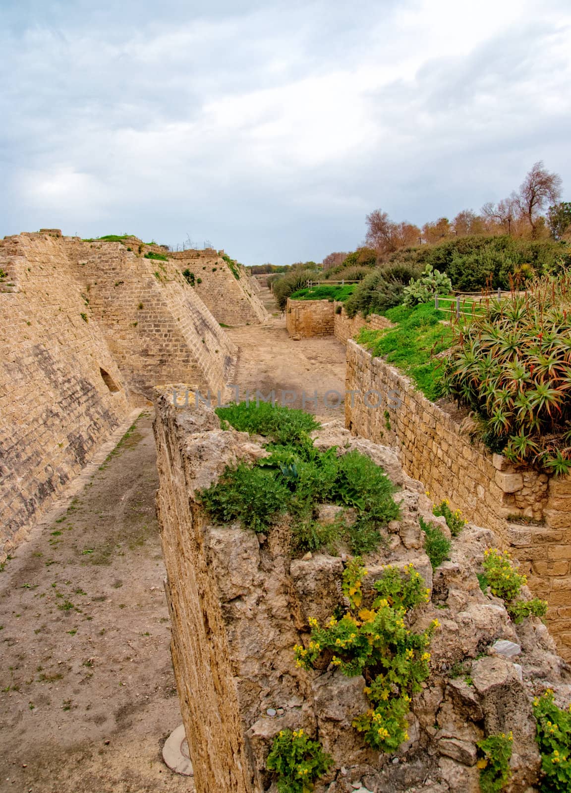 Ruins of the ancient Romanian harbor, Caesarea, Israel . by Zhukow