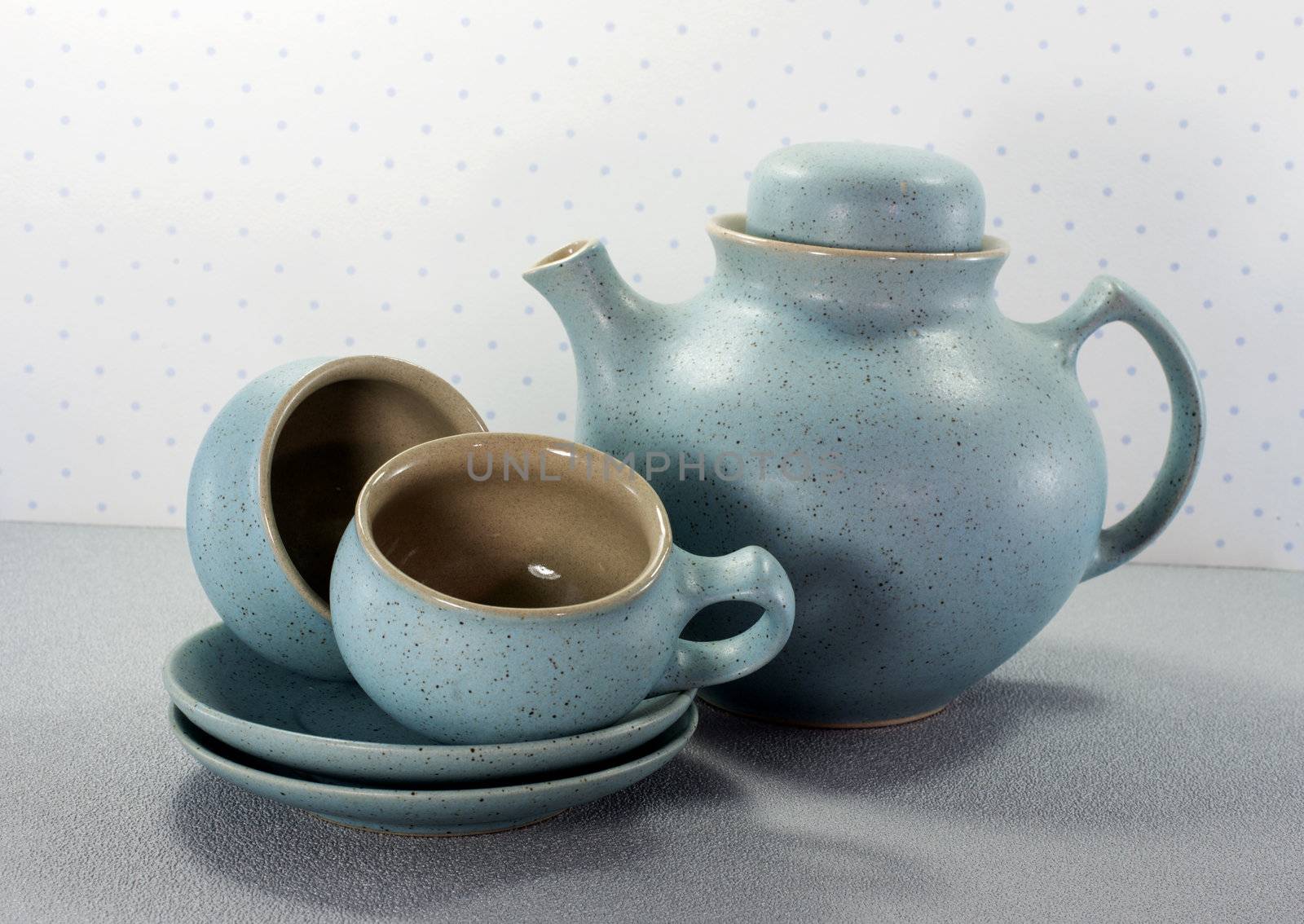 two crockery teacups and teapot 