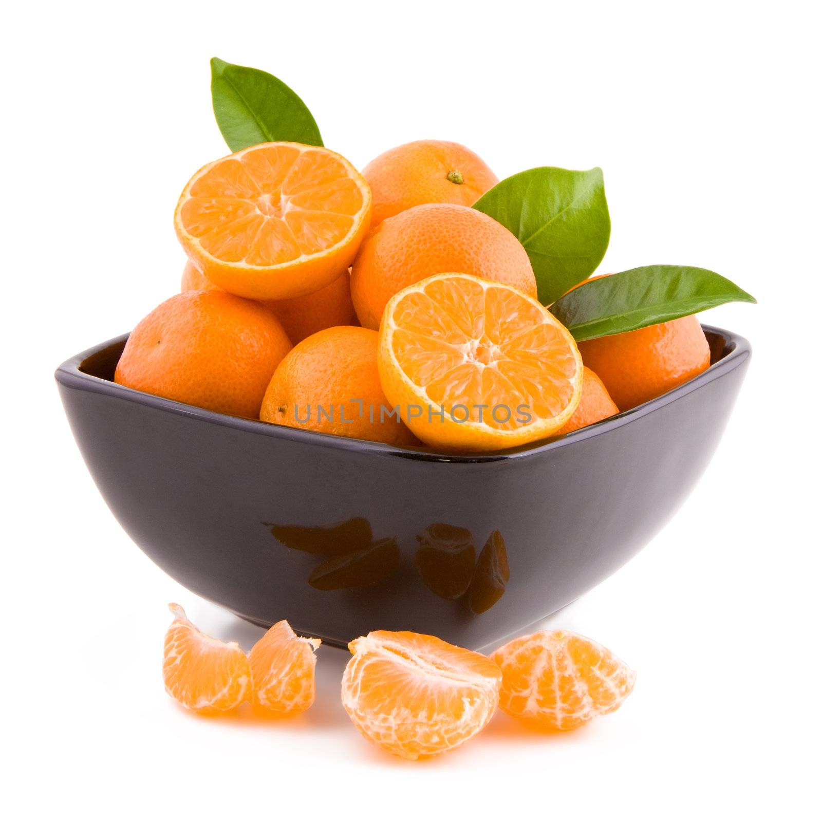 Fresh fruits tangerines in a black bowl isolated on white background