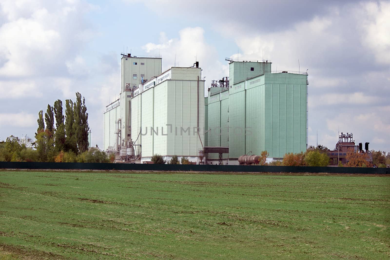 Large grain elevator rises among the fields