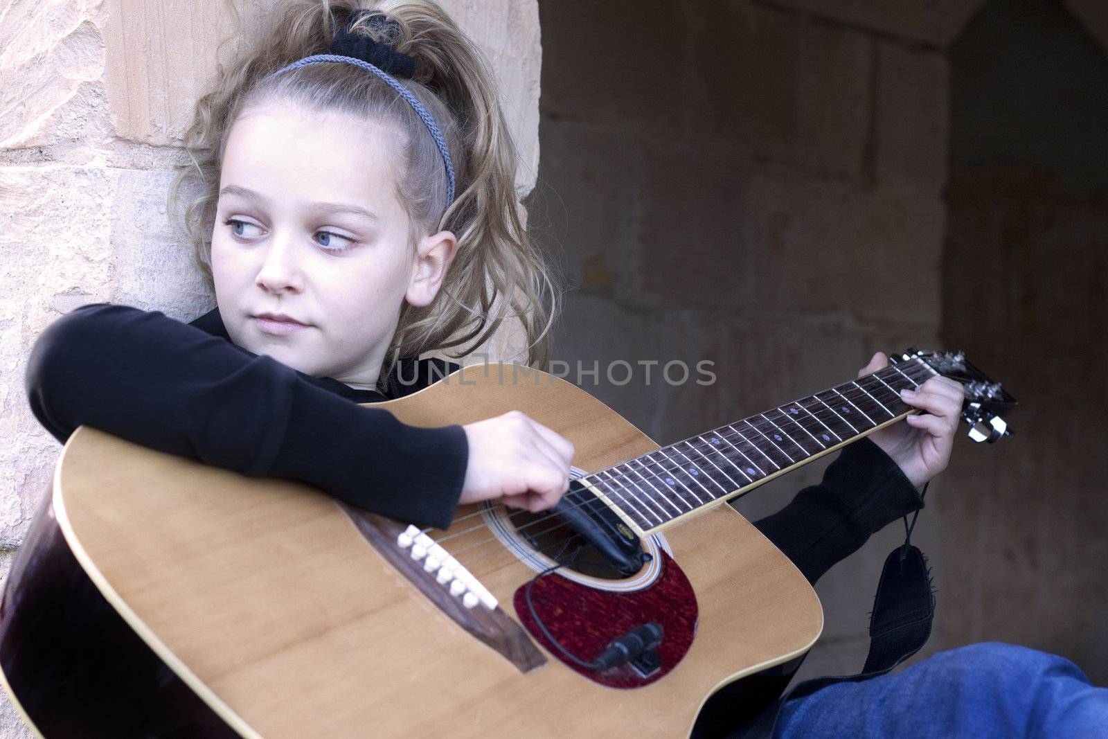 Child practicing her guitar