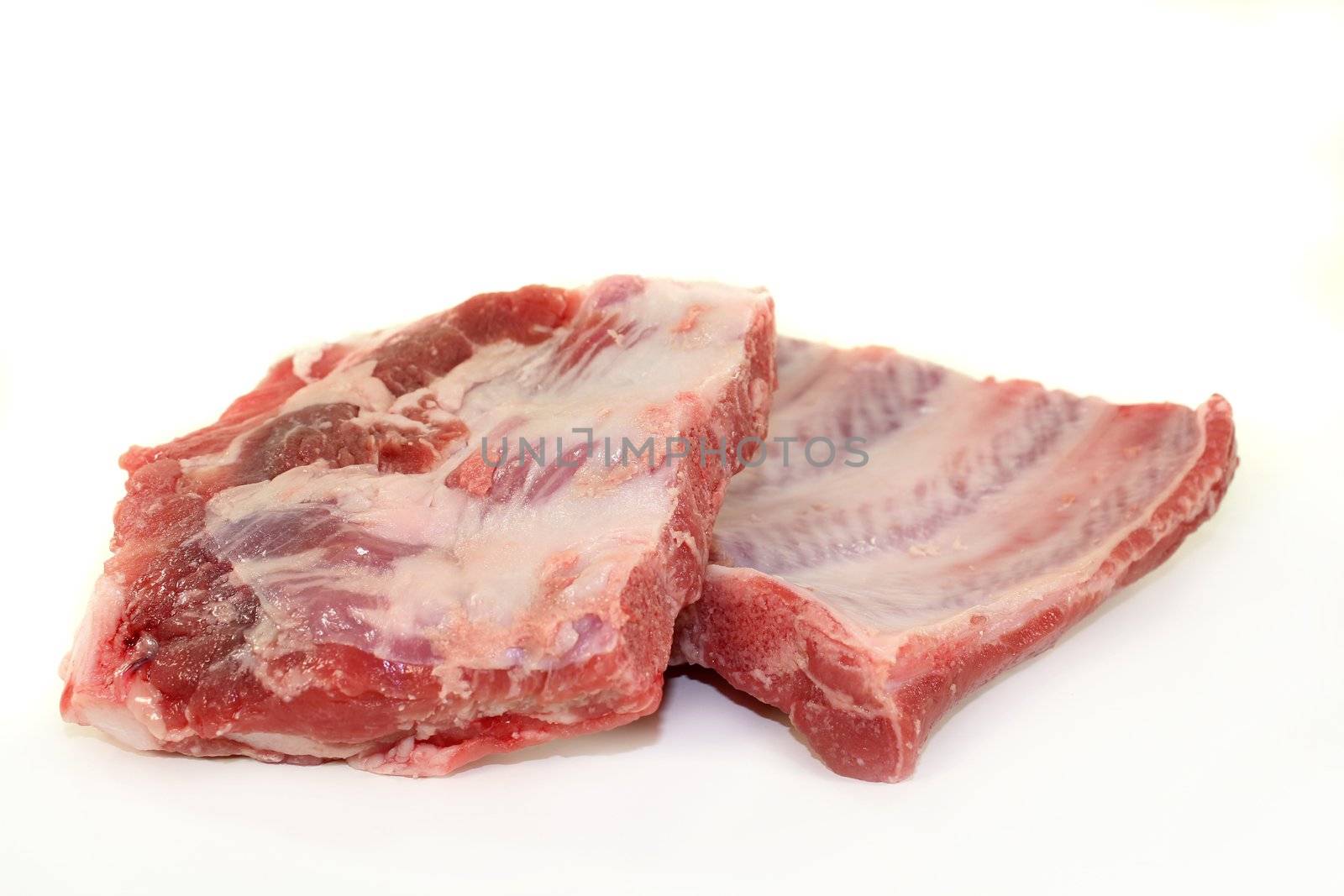 two pieces of spare ribs on a white background