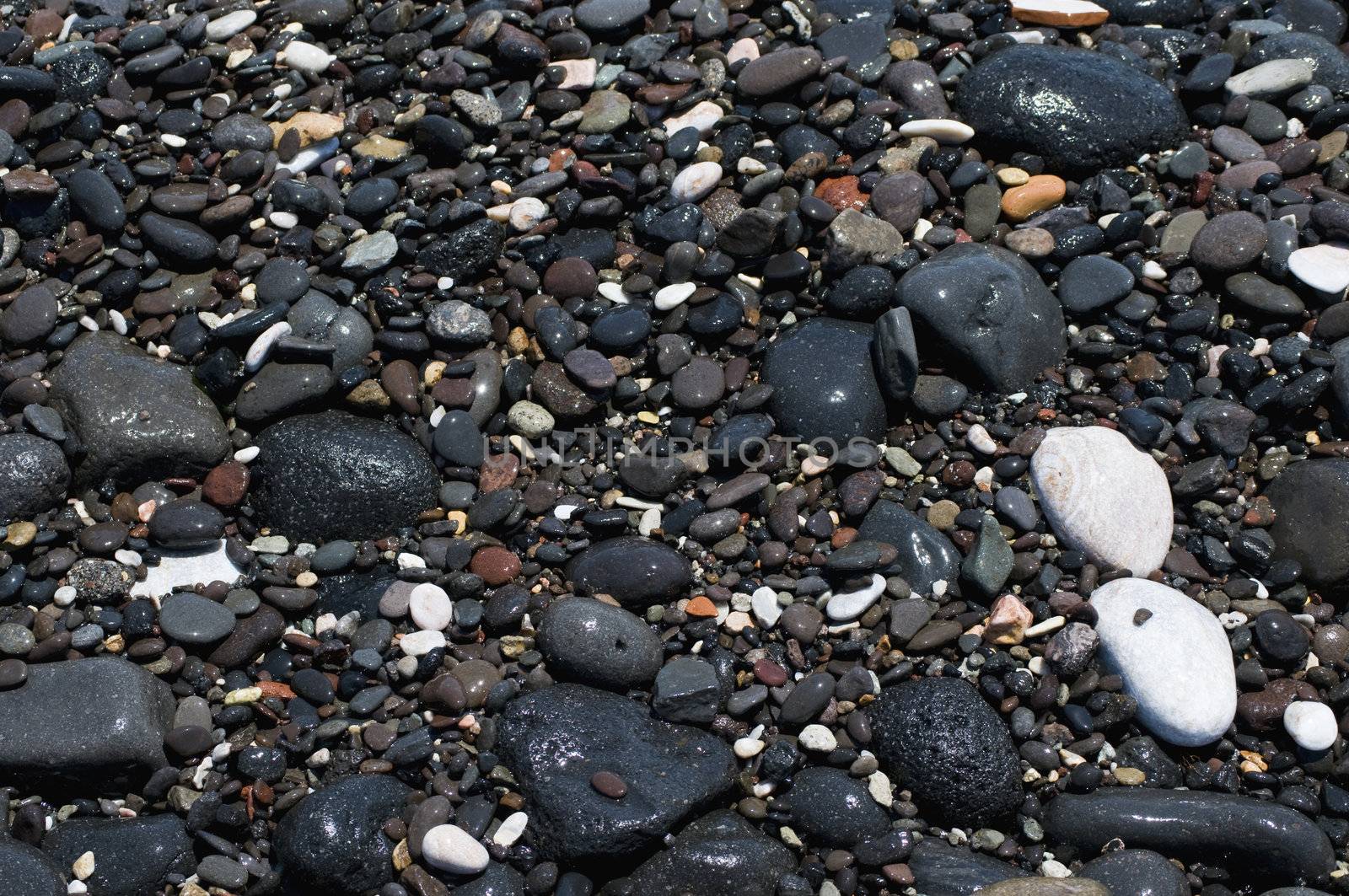 Black Stones on the Beach of Santorini, Greece