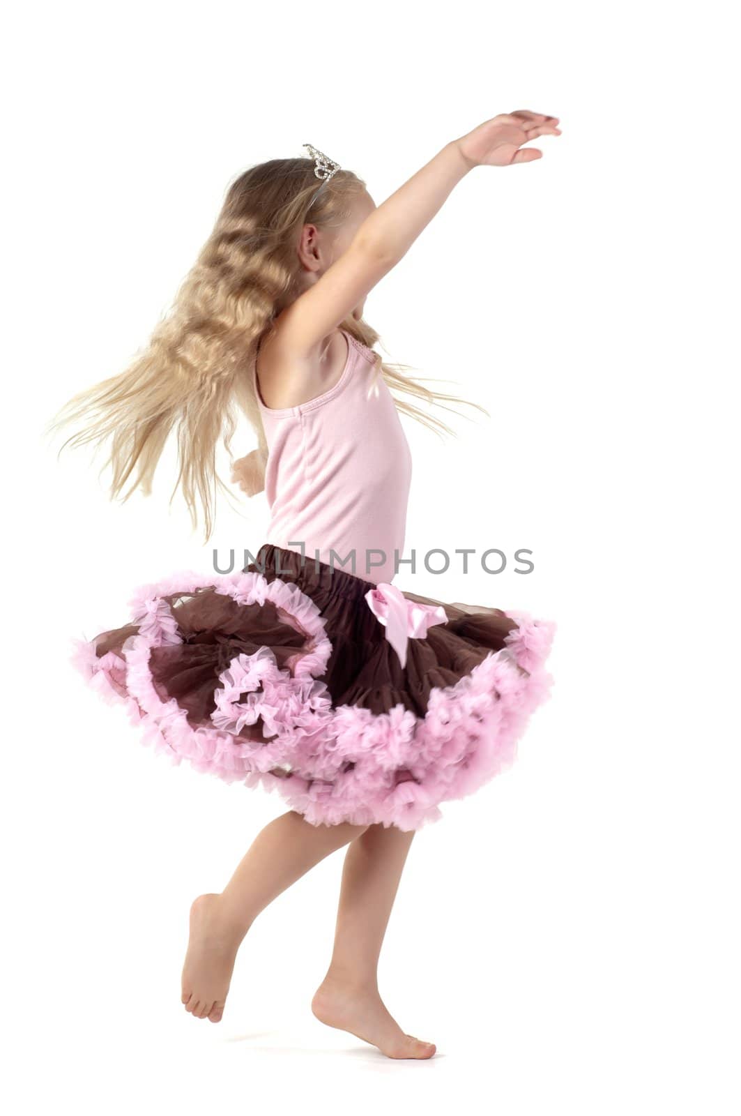 Shot of dancing little girl with long blond hair in studio