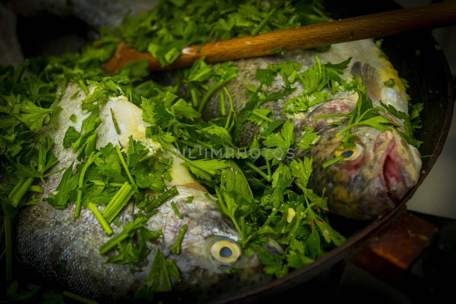 Two raw trouts in the frying pan ready to cook