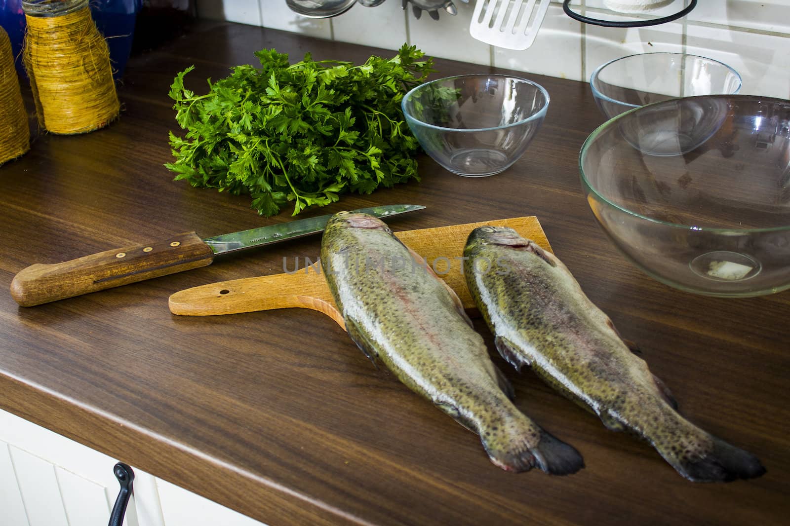 Two raw trouts on the kitchen table, ready to cook