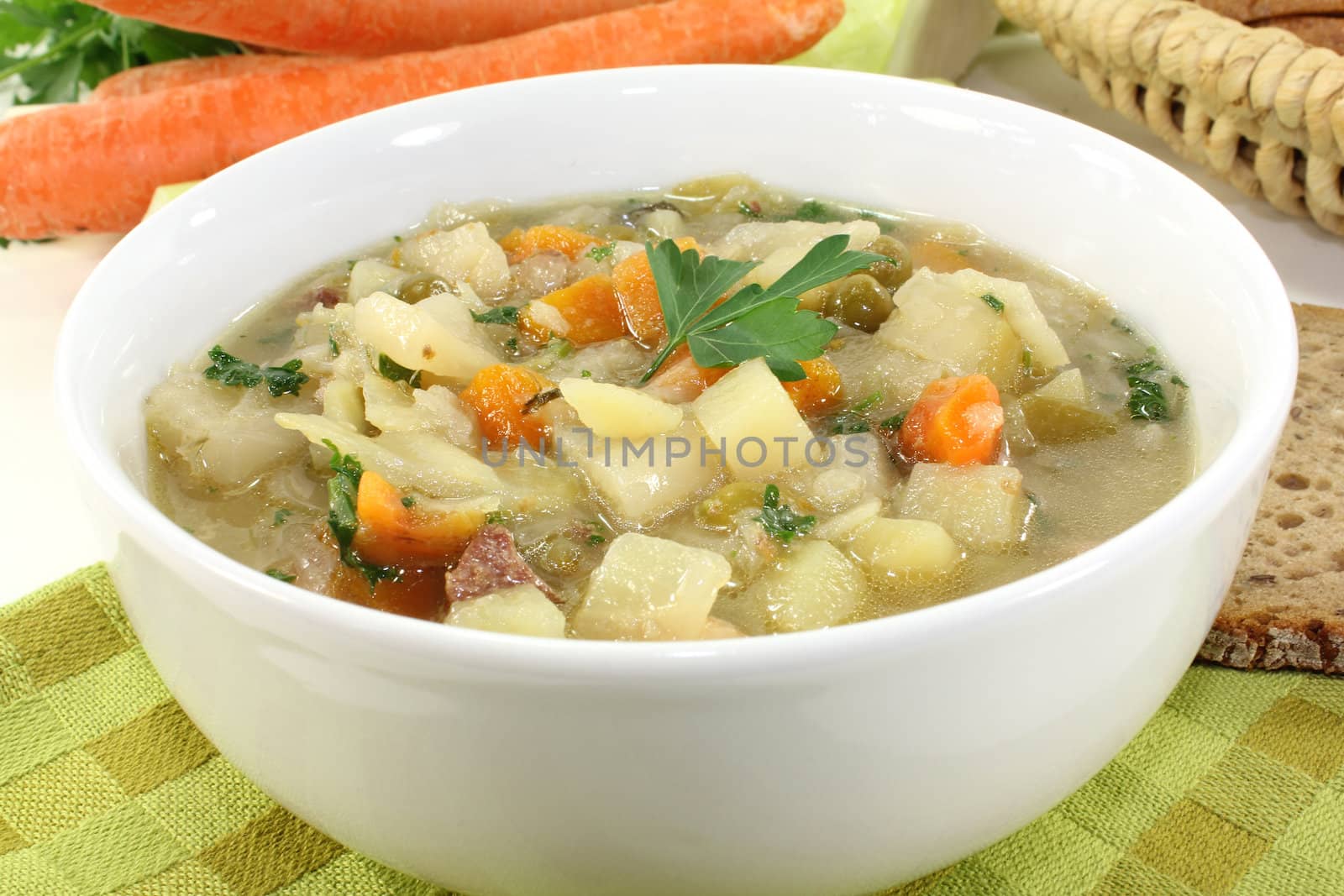 a bowl of cabbage soup and fresh parsley