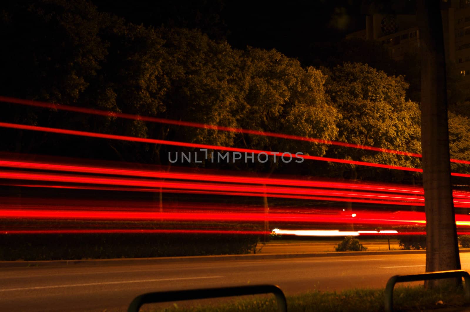 a night shot of vehicles on city street