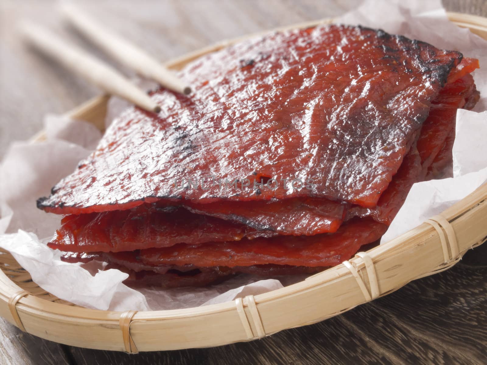 close up of a basket of chinese pork jerky