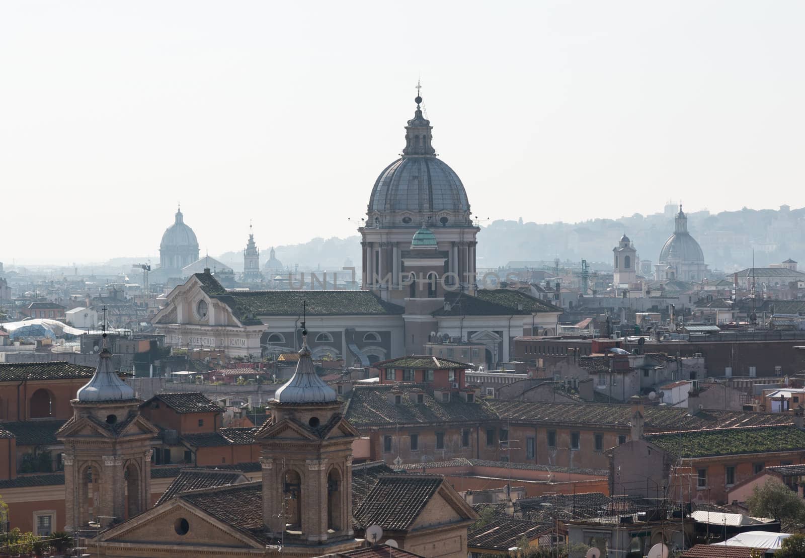 Basilica church of San Carlo al Corso in the skyline of Rome Italy with smog in the distance