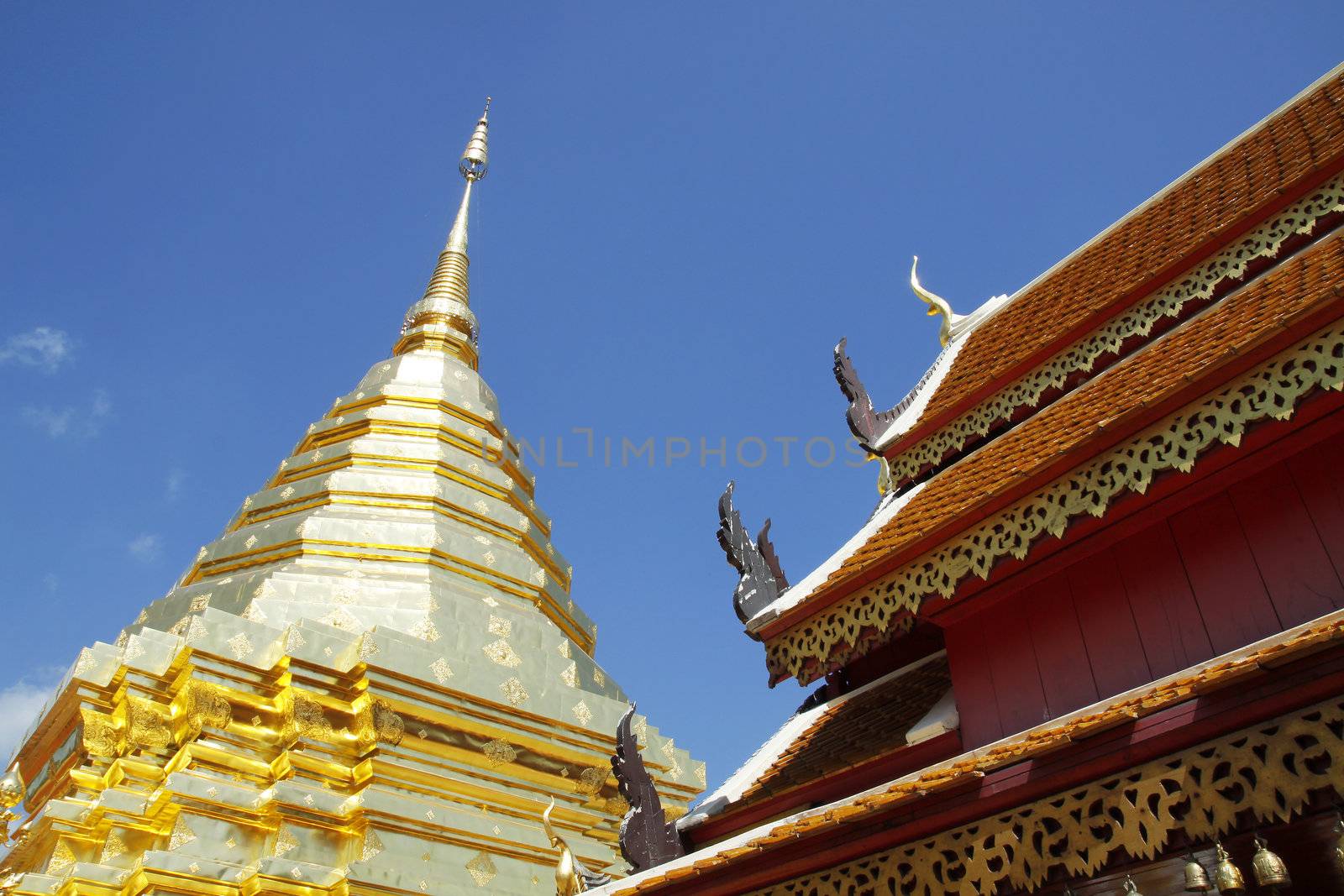 The golden pagoda with blue sky at Wat Phra That Doi Suthep, Temple Chiang Mai Province north Thail. Wat Phra That Doi Suthep contains the Holy Buddha Relic