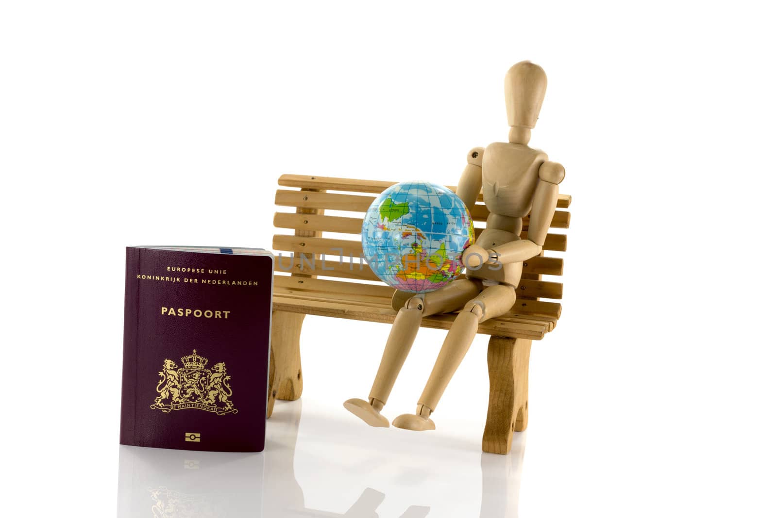 man on bench looking on globe for travel destination