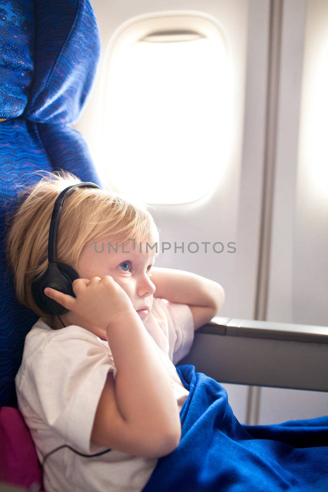 child with headphones in the plane by vsurkov