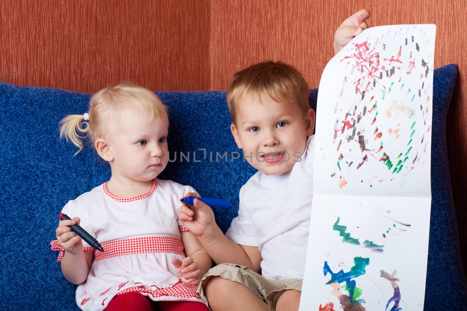 small boy and girl showing painting