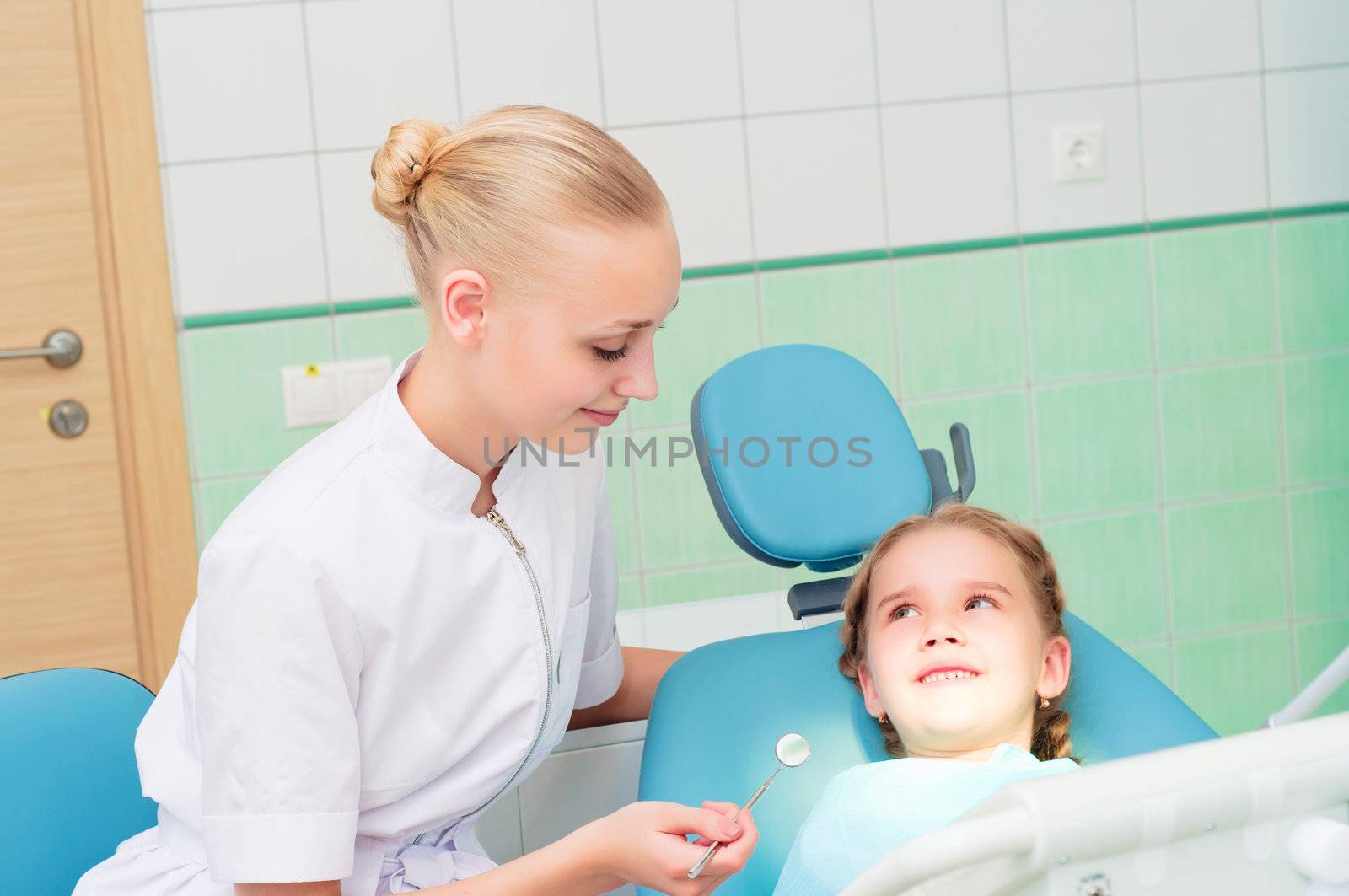 young doctor woman and girl in dentist office, regular visits to the dentist