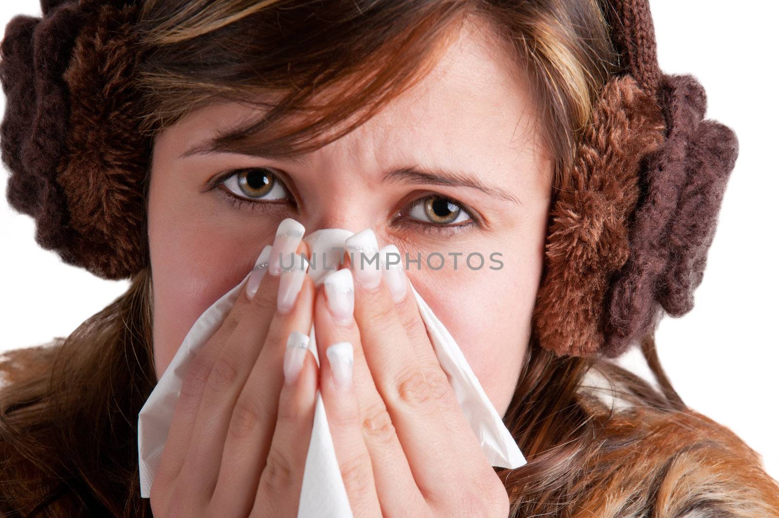Pale sick woman with a flu, sneezing, in a white background