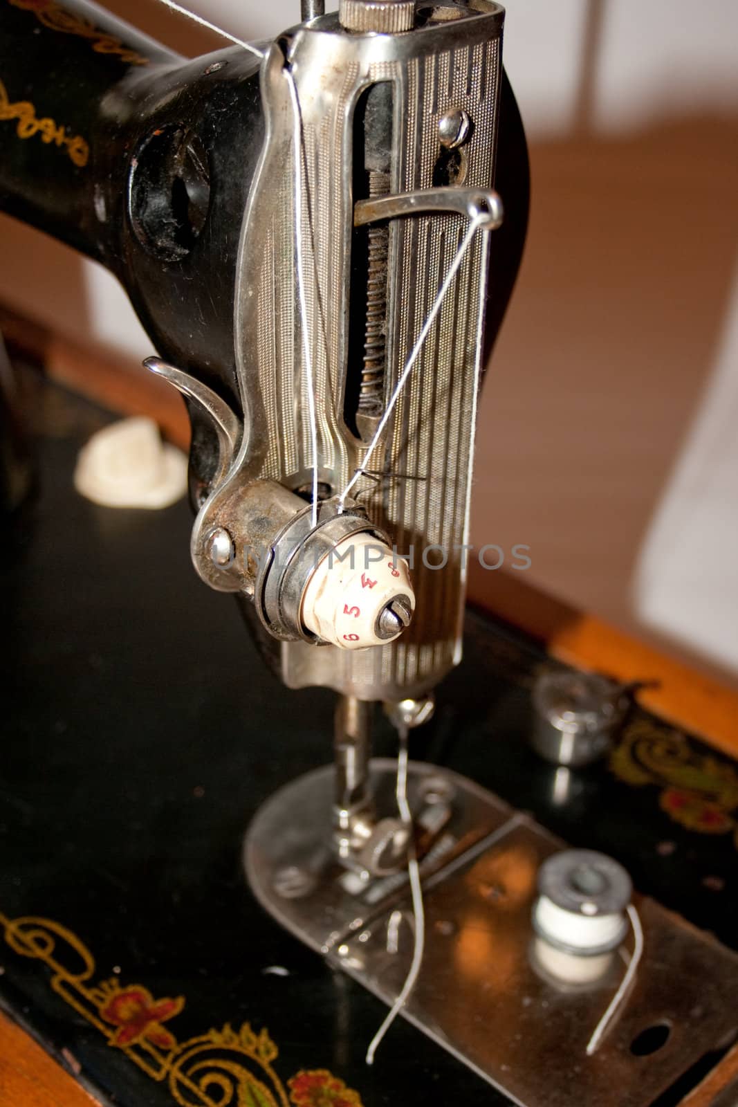 The antiquarian sewing-machine and hanks of threads