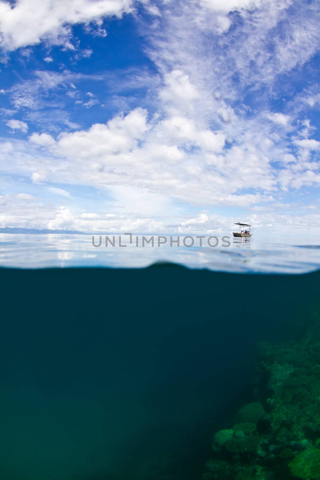 A lonely small boat is moored up at the great barrier reef in Australia.