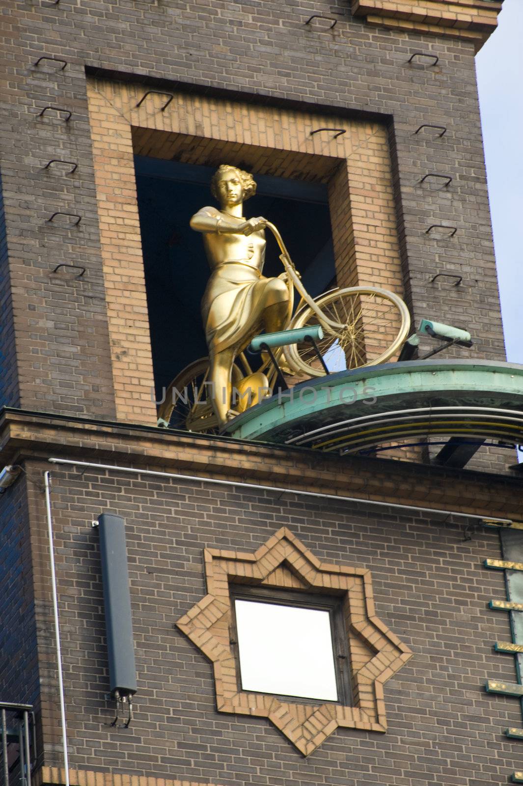 Sculpture of women the cyclist on a building facade in Copenhagen, Denmark. Taken on June 2012.