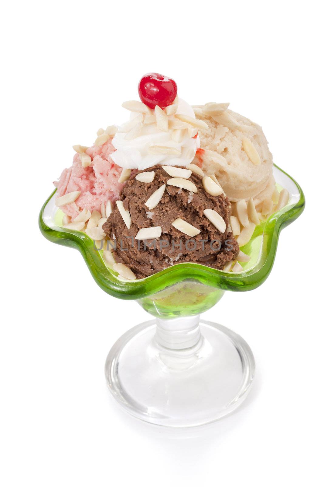Image of flavored ice cream scoop on a glass with icing and cherry on the top isolated on