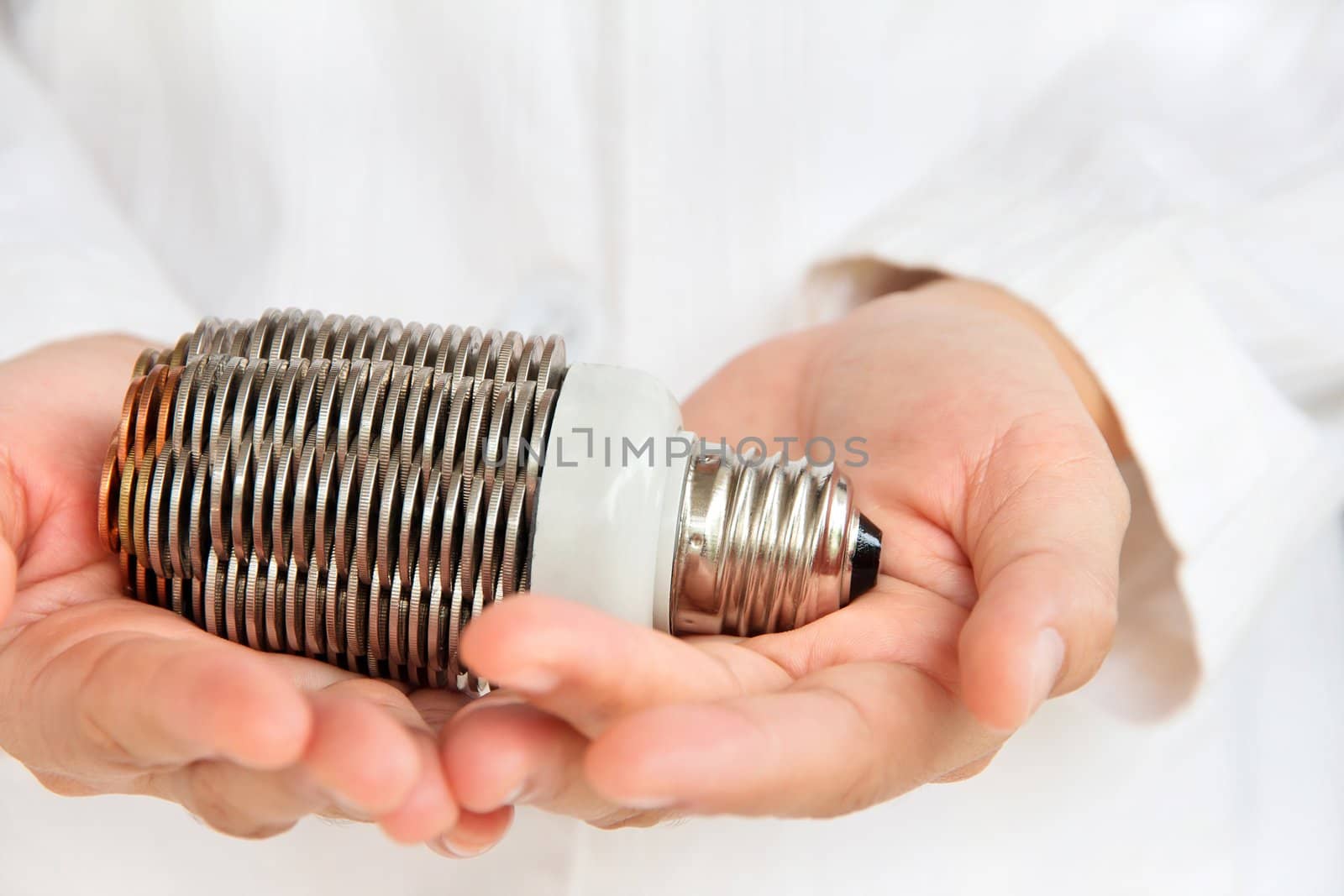 hand holding coin light bulb concept