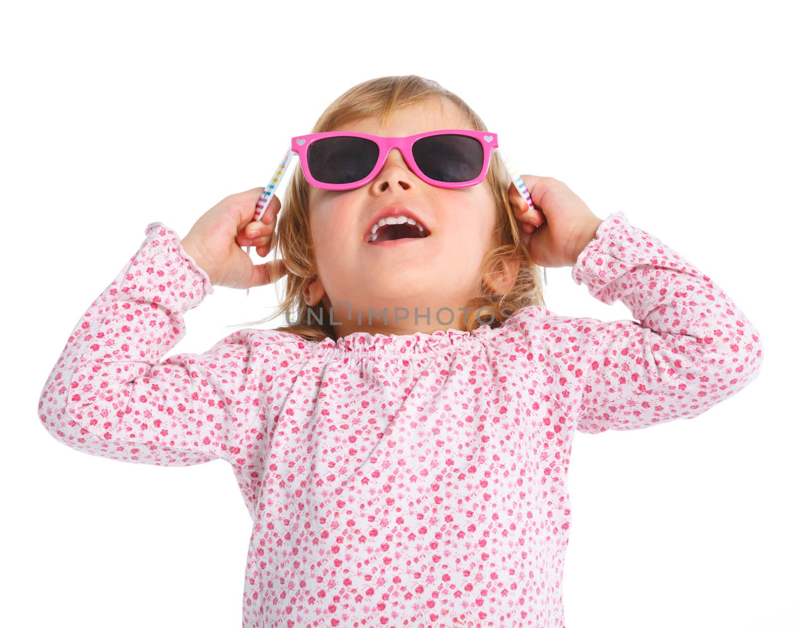 Portrait of little girl in pink dress and sunglasses looking up. Isolated white backround.