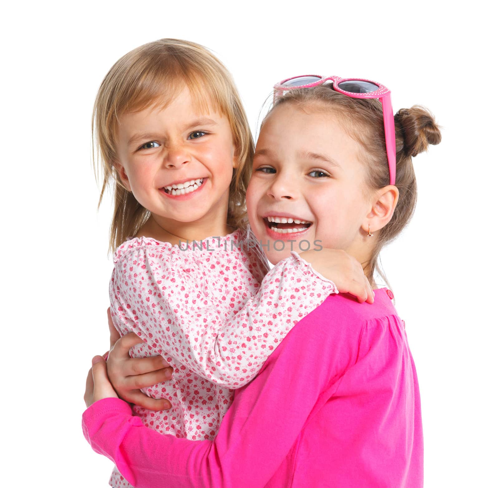 Two happy adorable smiling sisters. Isolated white background