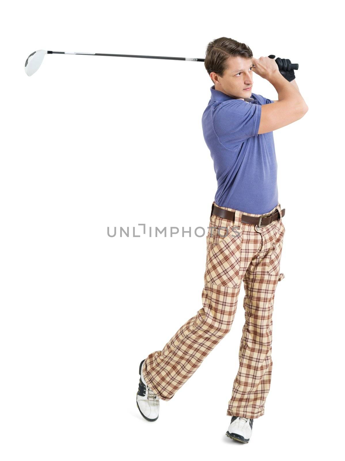 Photo of a male golfer in his late twenties finishing his swing with a driver.
