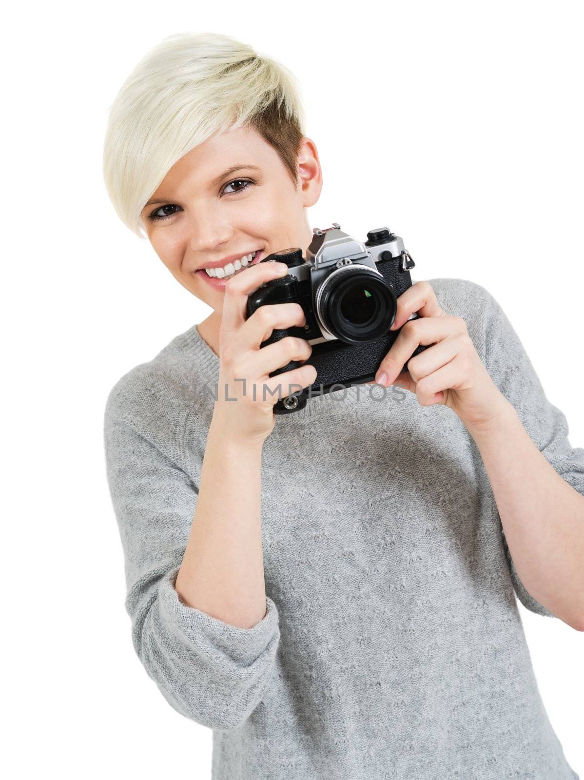 Photo of a beautiful young blond woman holding an old SLR film camera.
