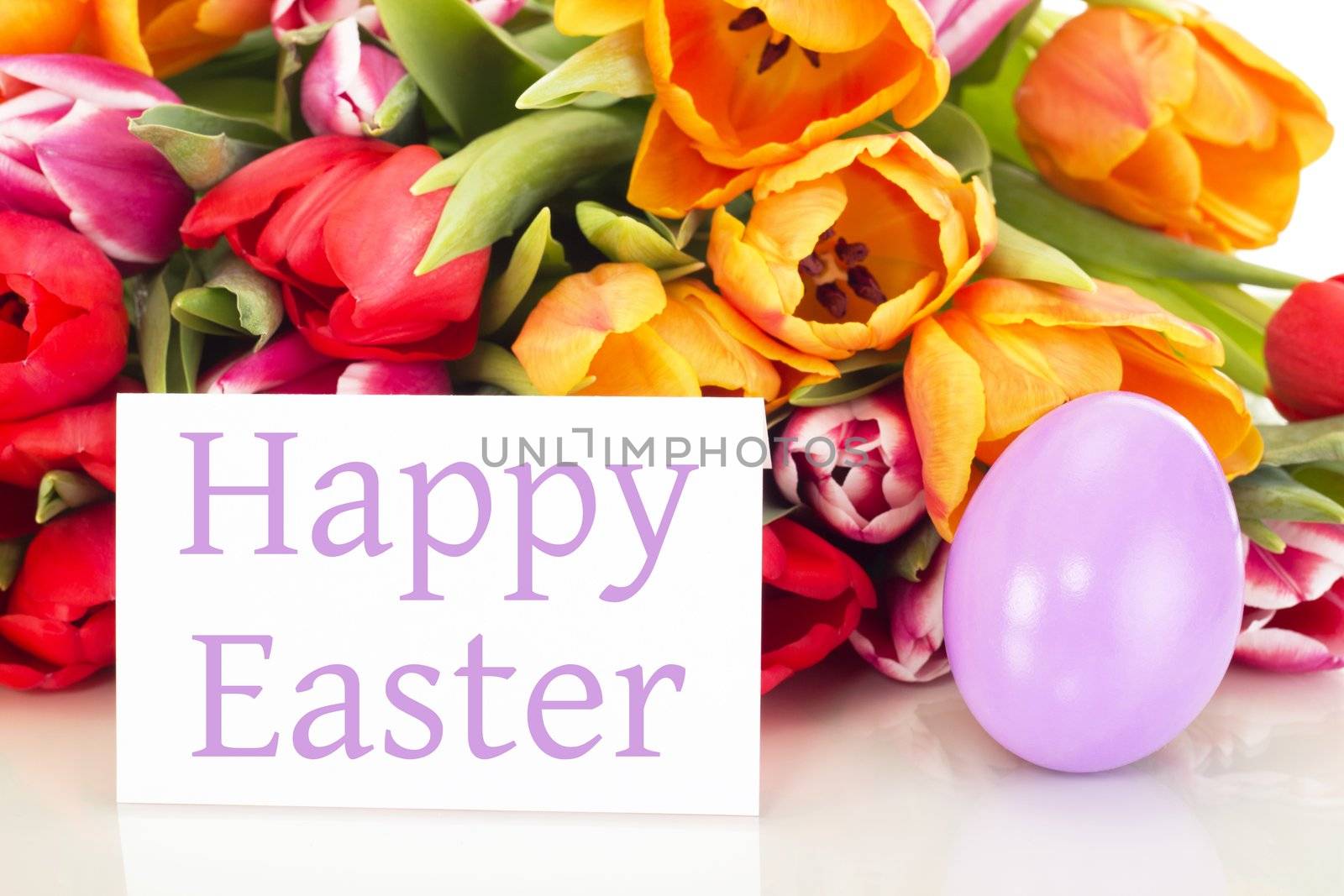 Bunch of tulips with easter egg and card: happy easter
