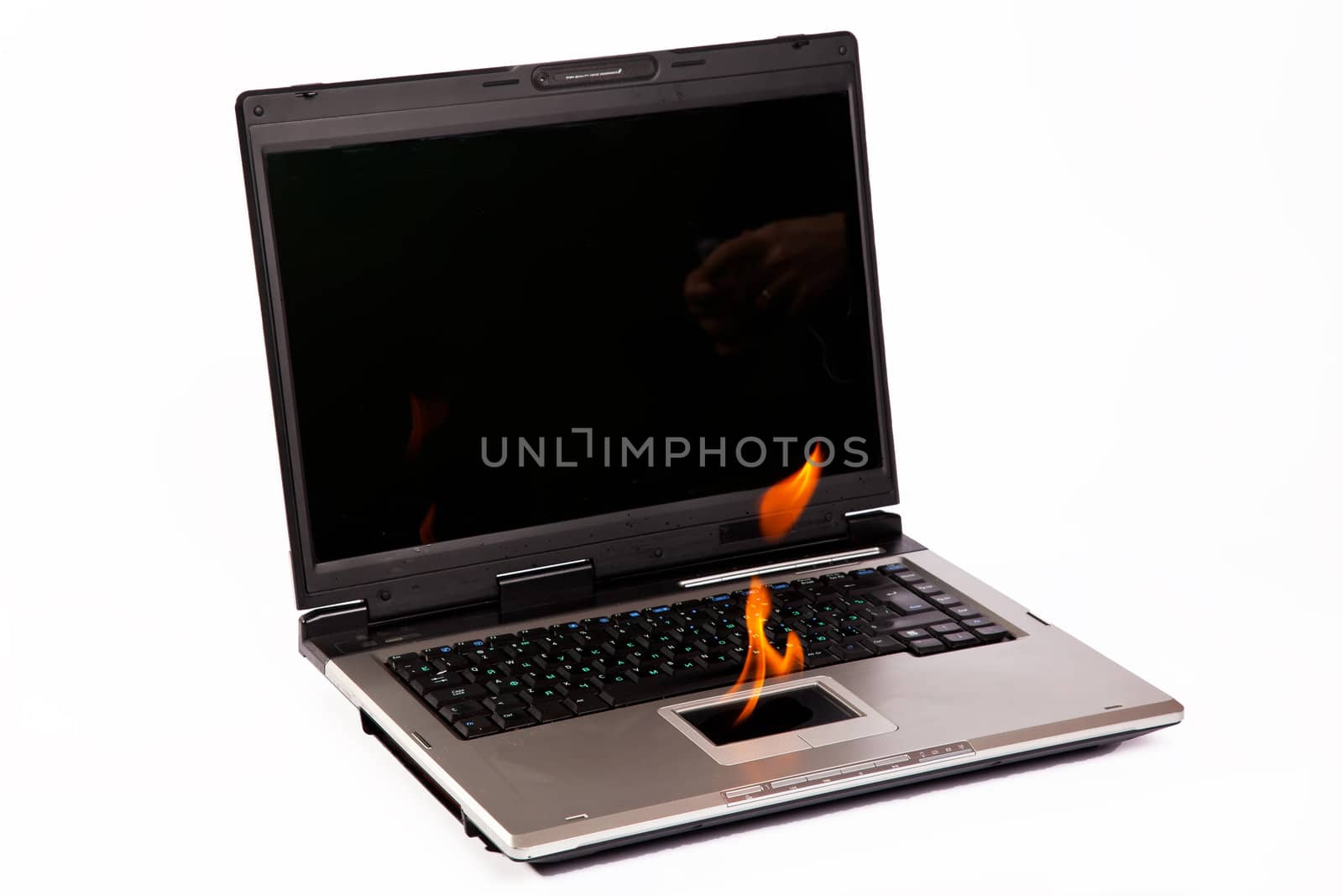 Laptop burning with fire on touchpad on white background
