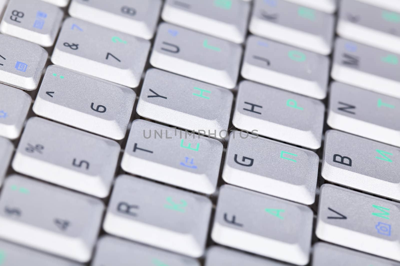 Laptop keyboard silver colur with letters and numbers on it