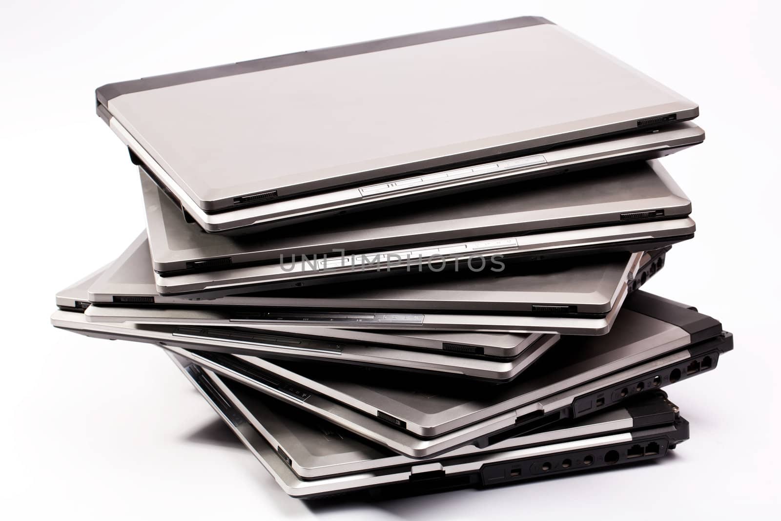 Pile of laptops on the white background