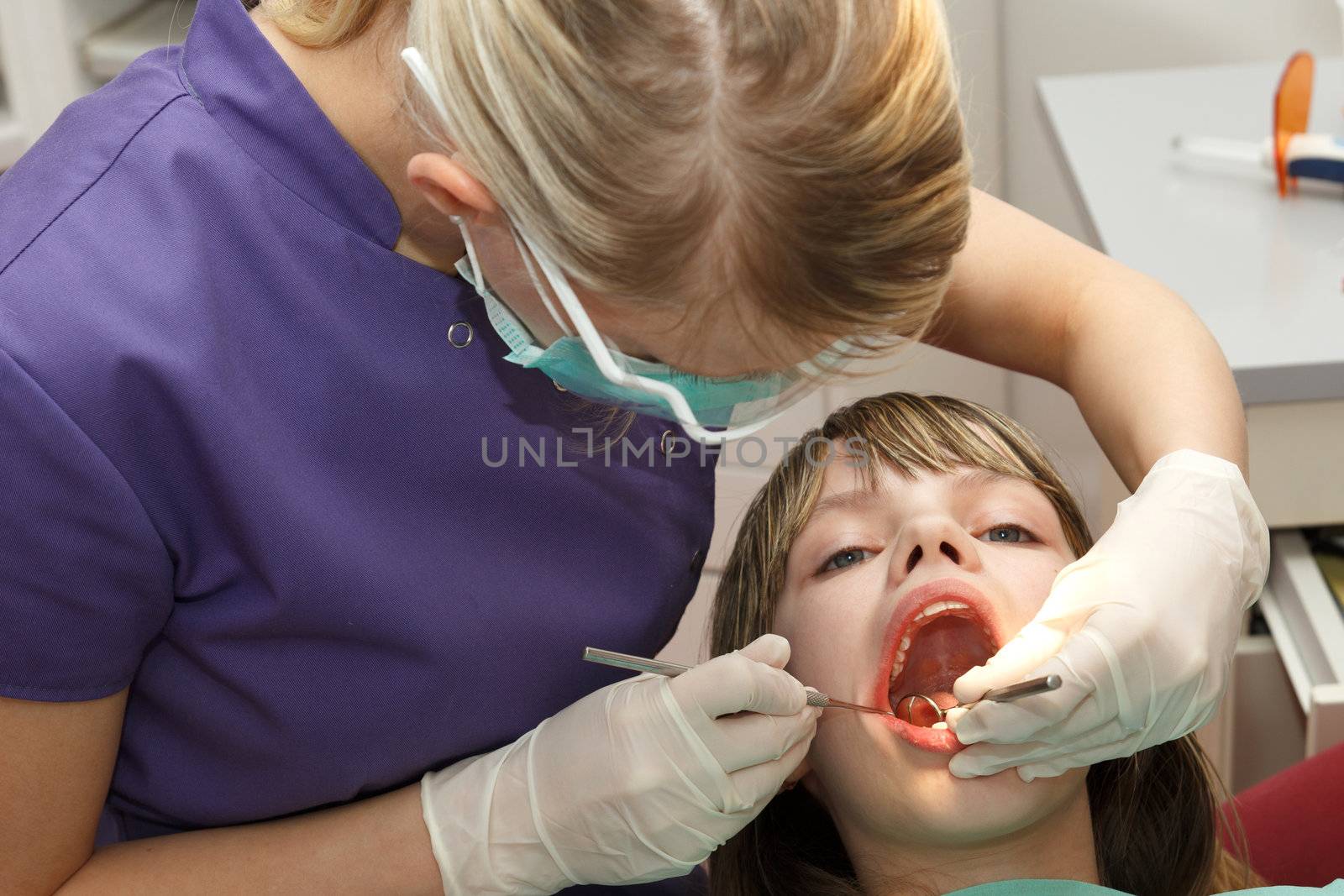 dentist check young girl teeth